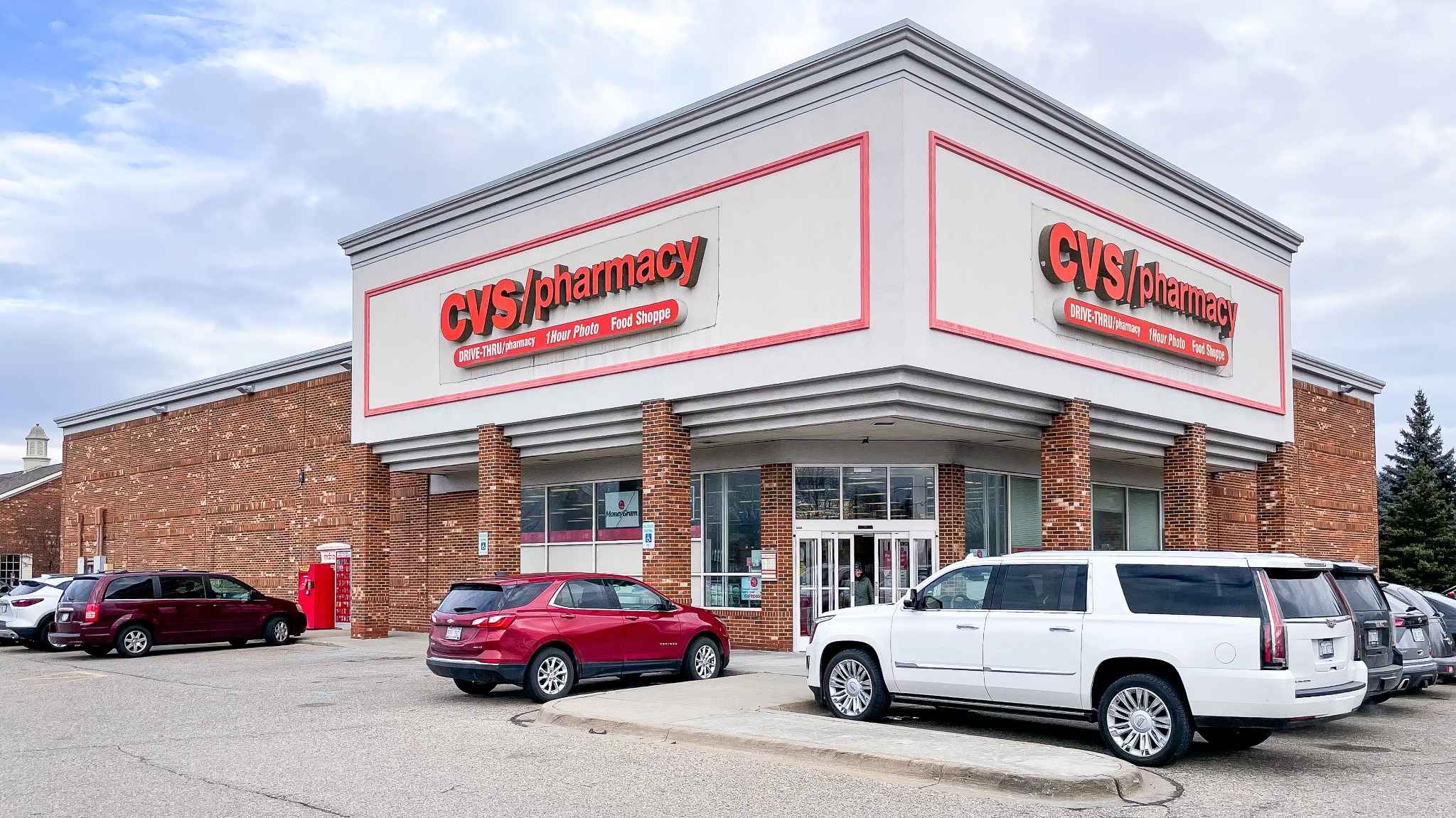 Exterior view of a CVS Pharmacy store with cars parked outside