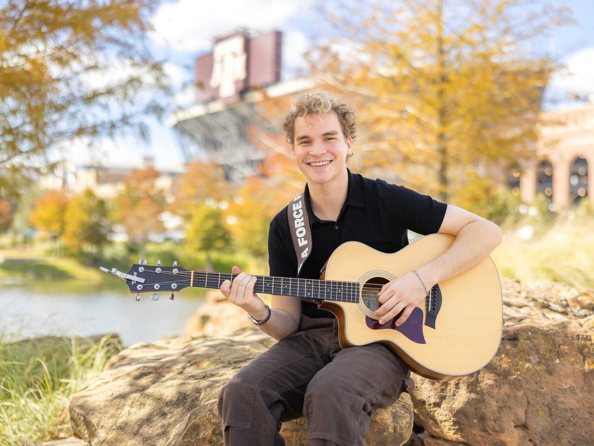 Aiden Ross, winner of The Voice Season 28, pictured with acoustic guitar
