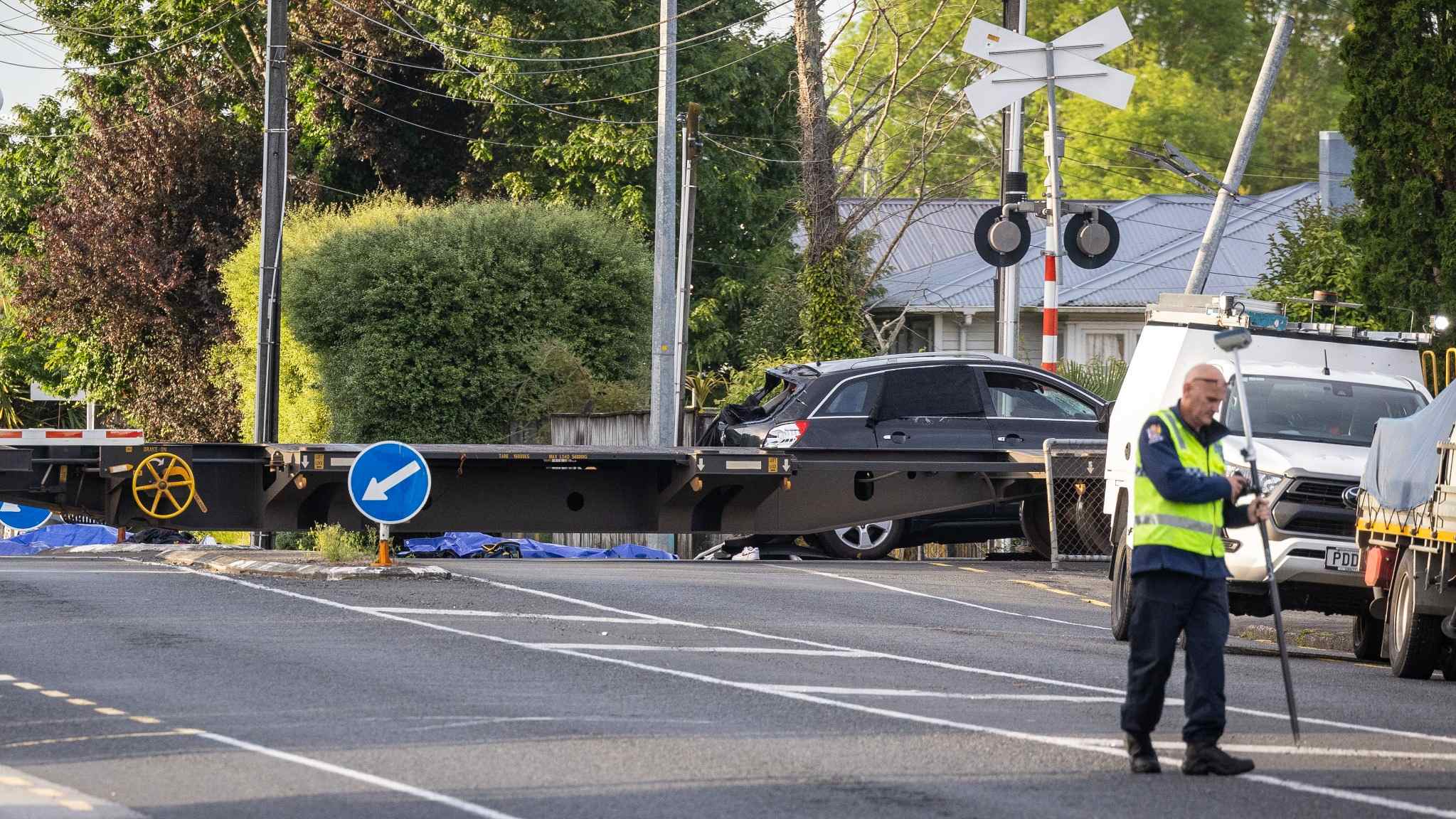Police and emergency crews at the Hamilton rail crossing crash scene after the vehicle was struck by a train