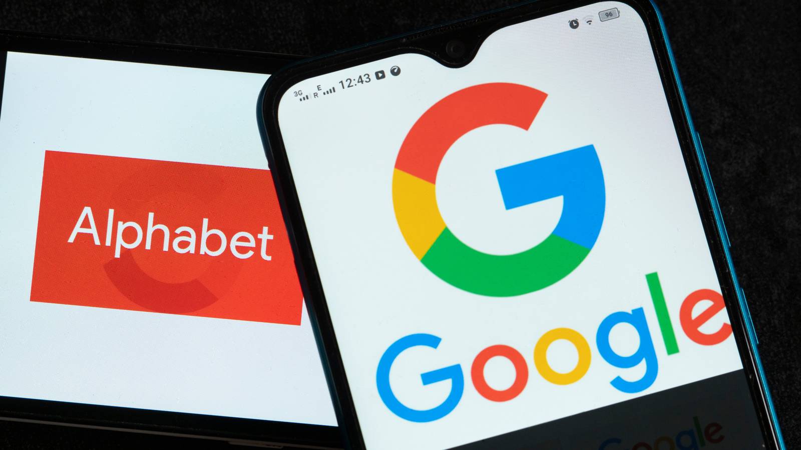 Alphabet and Google logos displayed on smartphone screens