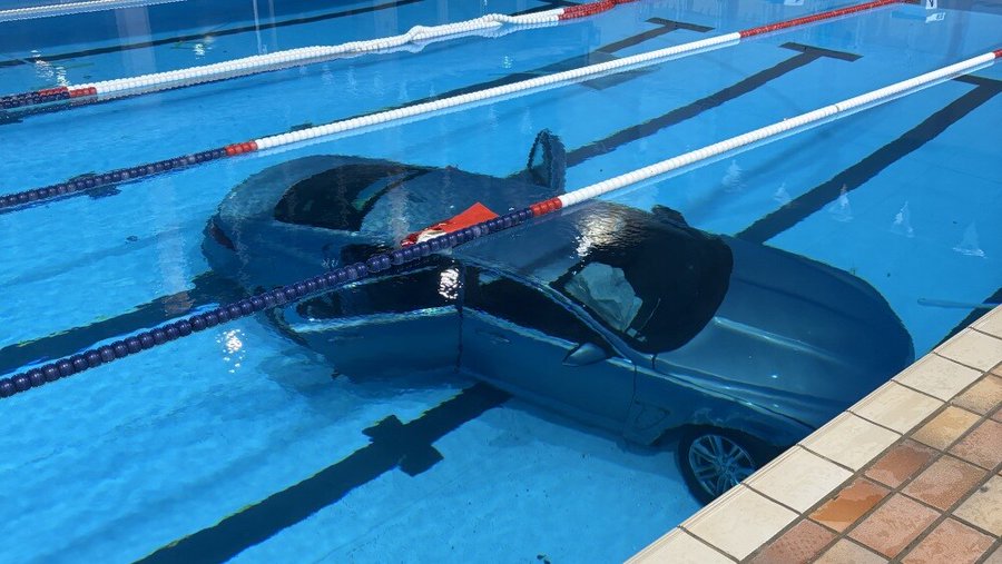 Car submerged in a public swimming pool in France after crashing through glass