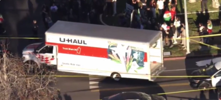 Police detain a man after a U-Haul truck drove into a crowd during an anti-Iran protest in Westwood, Los Angeles