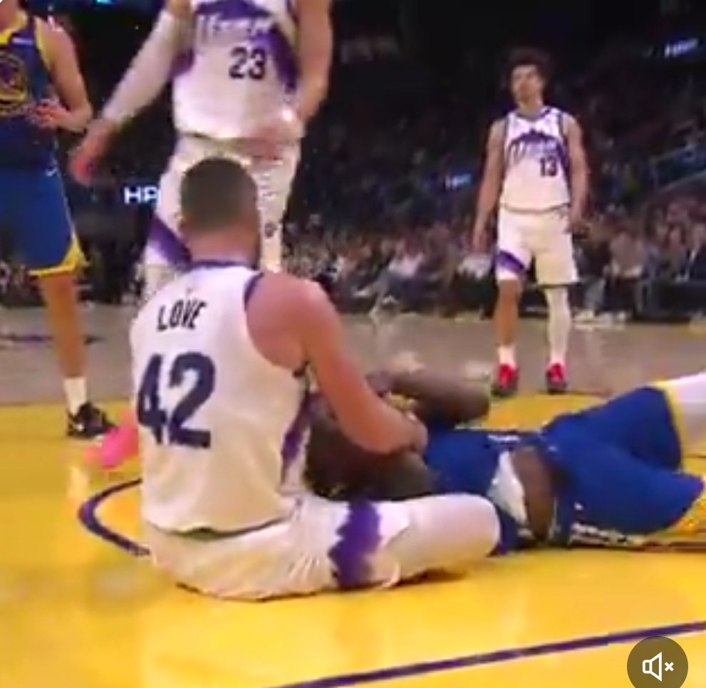 Kevin Love and Jimmy Butler seated on the court during Warriors vs Jazz moment