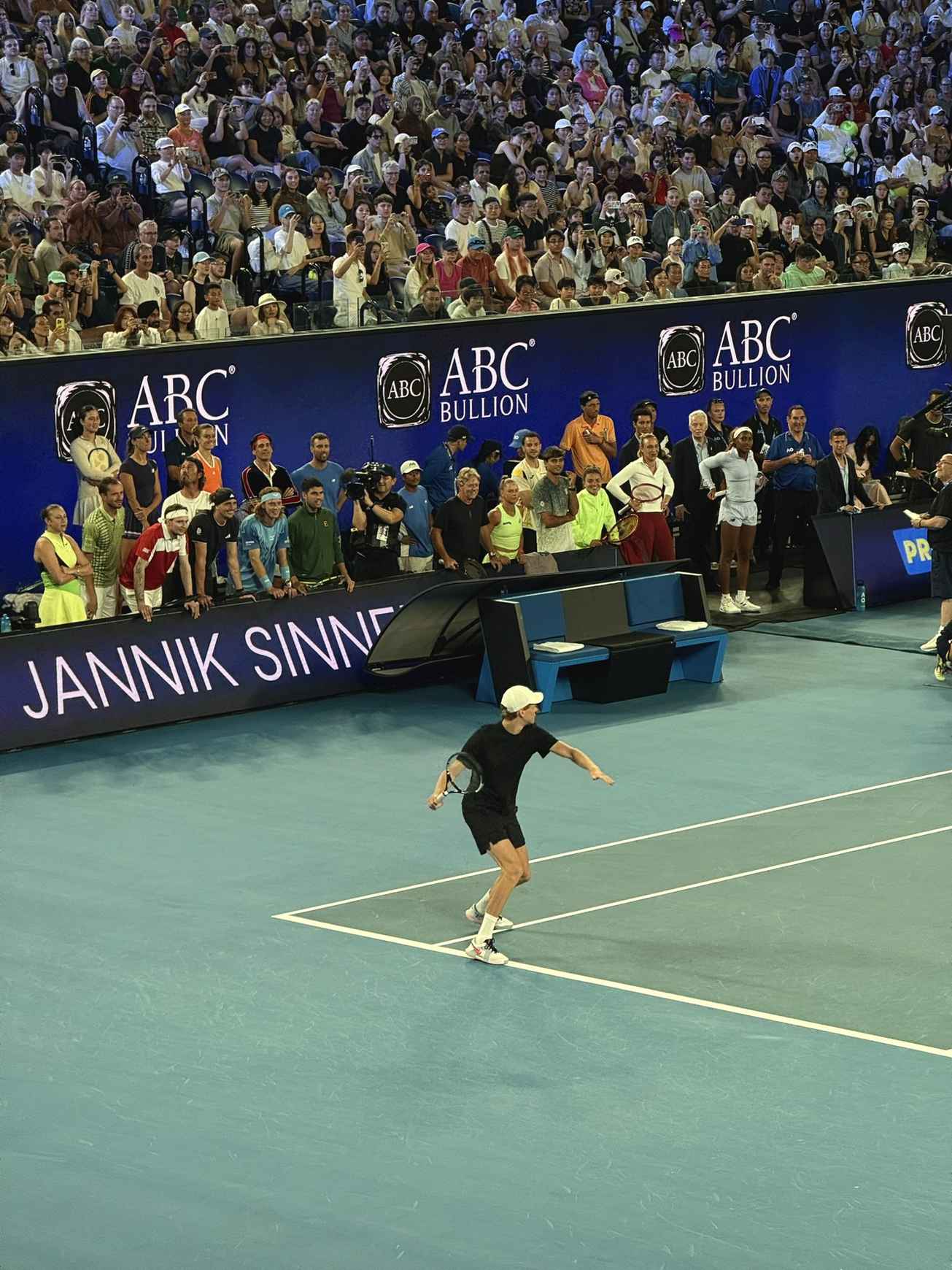 Crowd watches a player hit a shot during the Australian Open one-point slam at Rod Laver Arena.