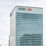 HSBC headquarters building in Canary Wharf London with modern glass facade under cloudy daylight sky