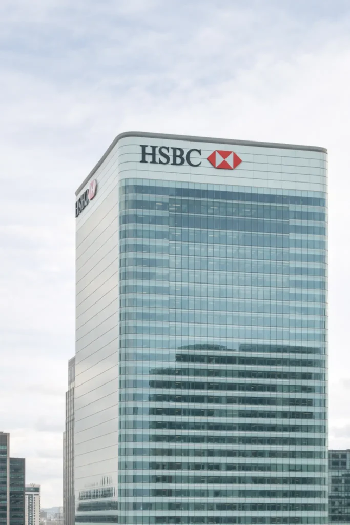 HSBC headquarters building in Canary Wharf London with modern glass facade under cloudy daylight sky