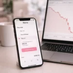 Klarna app on smartphone with stock chart showing sharp price drop