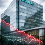 Siemens Aktiengesellschaft headquarters in Munich with subtle red stock chart reflection representing share price decline on XETRA