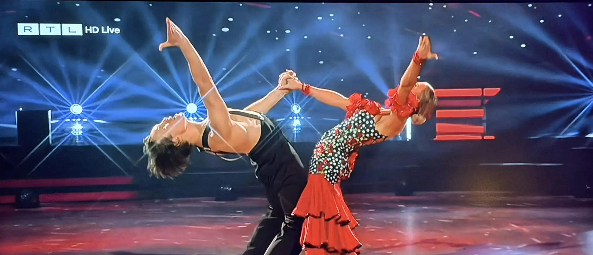 Live dance performance on a brightly lit stage