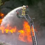 Kingston tyre shop fire leaves one injured as Logan residents warned over smoke