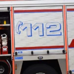 Fire engine parked at an emergency response scene in Finland following the Kemi sulphuric acid leak, with rescue equipment and the emergency number 112 visible on the vehicle.