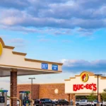 Buc-ee's travel center with fuel pumps and the iconic beaver logo as the company expands new locations across the United States in 2026.