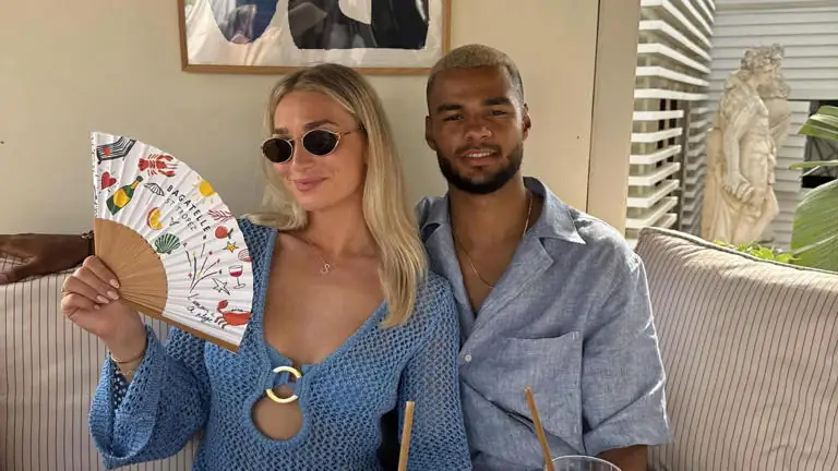 Cody Gakpo and partner Noa van der Bij sitting together indoors, smiling for a photo before the 2026 FIFA World Cup, following news of their family tragedy.