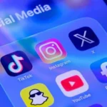 Social media app icons including TikTok, Instagram, X, Facebook, YouTube and Snapchat displayed on a smartphone screen, illustrating Australia's tougher social media regulations and proposed A$99 million fines for platforms that fail to enforce the under-16 ban.