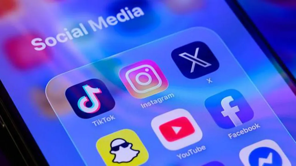 Social media app icons including TikTok, Instagram, X, Facebook, YouTube and Snapchat displayed on a smartphone screen, illustrating Australia's tougher social media regulations and proposed A$99 million fines for platforms that fail to enforce the under-16 ban.