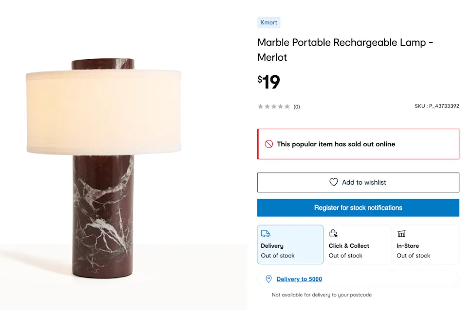 Kmart storefront with a shopper holding the $19 Marble Portable Rechargeable Lamp after the viral homeware item sold out within hours of launch