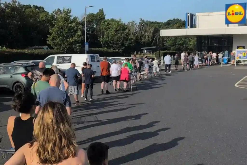 Shoppers queue outside a Lidl supermarket to buy a £149 portable air conditioner during the UK heatwave as demand for cooling appliances surges.