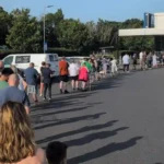 Shoppers queue outside a Lidl supermarket to buy a £149 portable air conditioner during the UK heatwave as demand for cooling appliances surges.