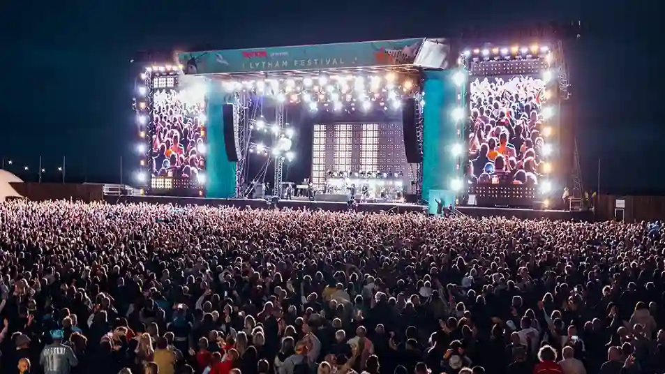 Crowds gather in front of the illuminated main stage during Lytham Festival 2026 at Lytham Green as thousands of music fans attend the five-day outdoor music festival in Lancashire, England.