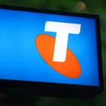 Telstra logo displayed on a blue sign during Australia network outage coverage.