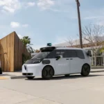 Waymo's new Ojai autonomous robotaxi driving on a city street during its U.S. expansion ahead of launches in Las Vegas, San Diego, Tampa and Denver.