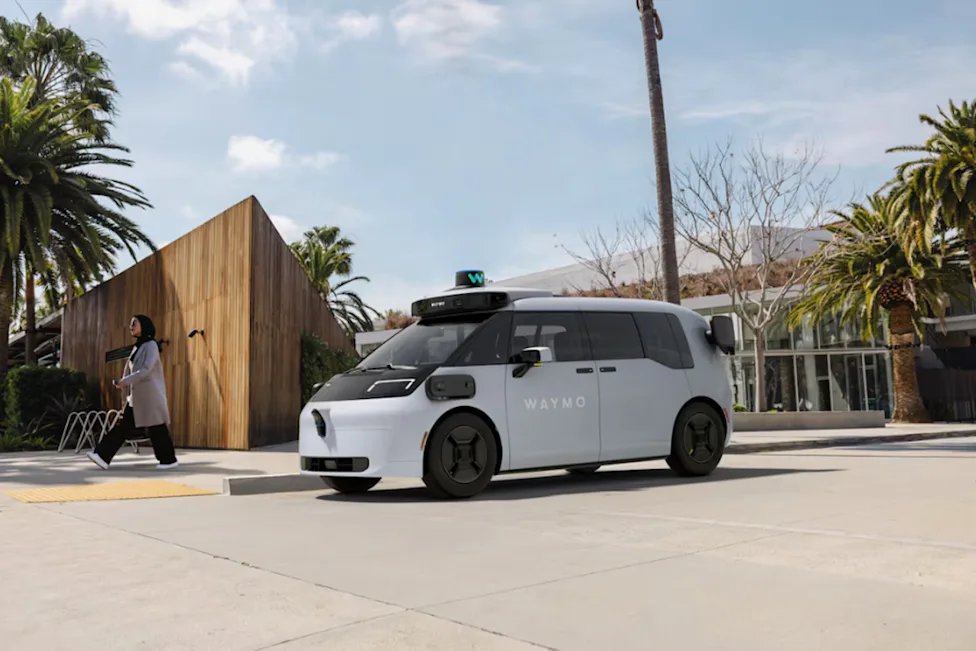 Waymo's new Ojai autonomous robotaxi driving on a city street during its U.S. expansion ahead of launches in Las Vegas, San Diego, Tampa and Denver.