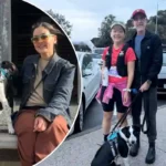 Yuko Frost with her husband and dog in Australia, highlighting the impact of the new $1,475 Resident Return Visa fee on permanent residents.