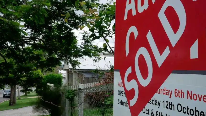 Australian property auction sold sign outside a residential home as auction clearance rates remain below 50% amid housing market slowdown