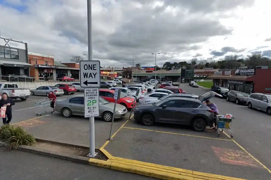 Cars parked in a shopping centre car park in Drouin, Victoria, where Baw Baw Shire Council announced refunds for drivers overcharged on certain parking fines