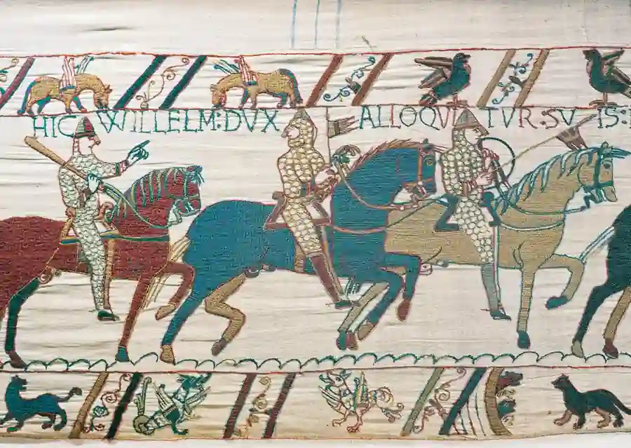 Bayeux Tapestry showing Norman horsemen and medieval embroidered scenes depicting the events leading to the Norman Conquest of England in 1066.