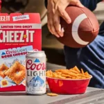 Cheez-It Coors Light Beer Cheese crackers with a Coors Light can, bowl of crackers and football.