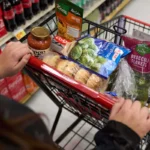 SNAP recipient shopping for groceries with an EBT card as new SNAP rules and work requirements take effect