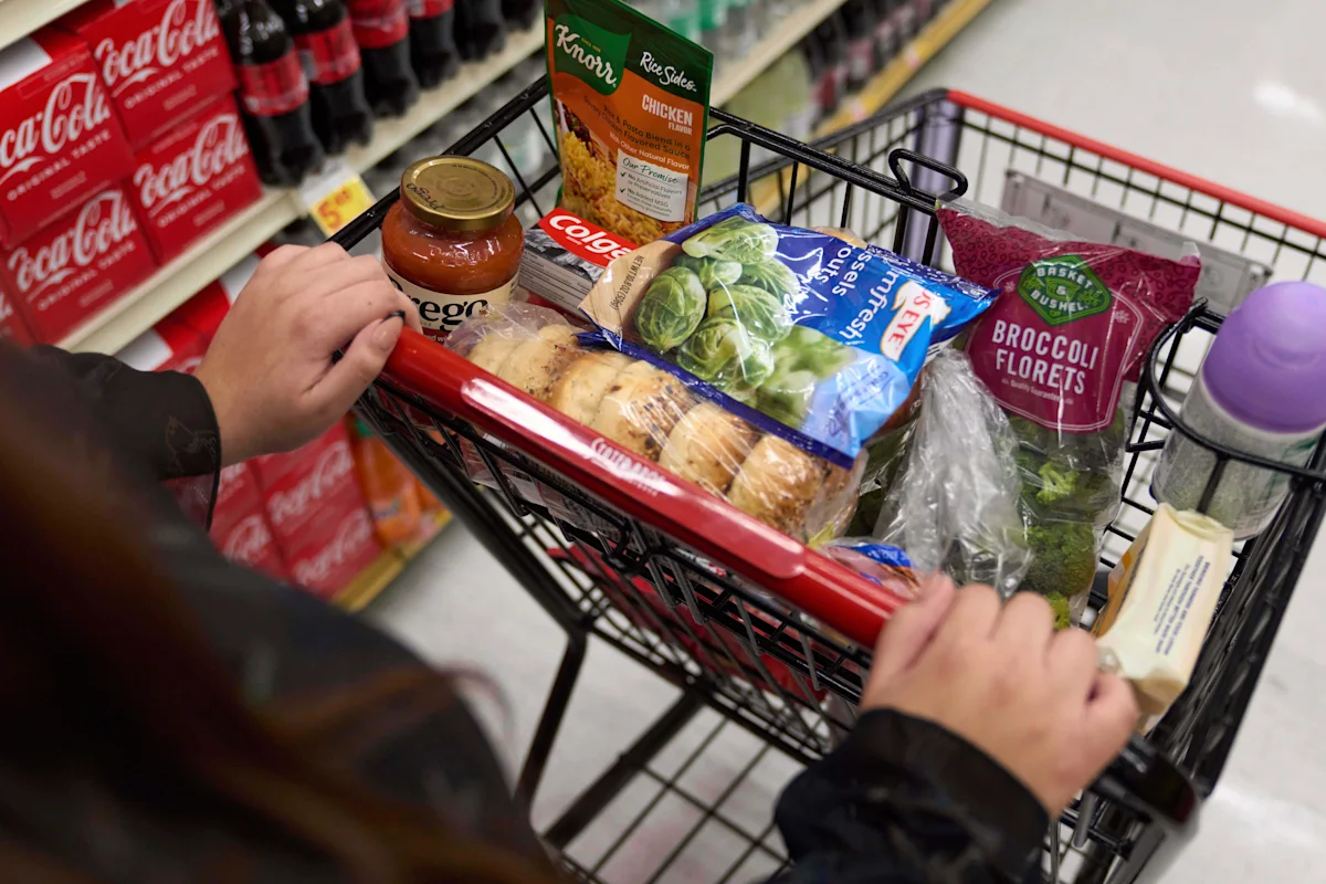 SNAP recipient shopping for groceries with an EBT card as new SNAP rules and work requirements take effect