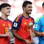 Pau CubarsĂ, Rodri and Unai SimĂłn holding their FIFA World Cup 2026 individual awards.