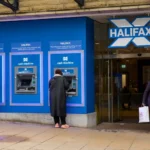 Halifax bank branch with customers using cash machines before Lloyds Banking Group's planned rebranding of the 173-year-old Halifax brand.