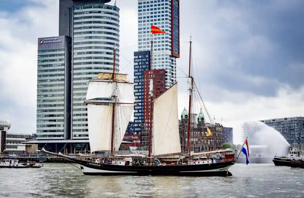 Sail4th 250 Parade with international tall ships sailing past the Statue of Liberty in New York Harbor during America's 250th anniversary celebration.
