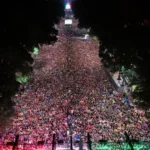 Massive crowd of Mexico fans celebrating at night after World Cup victory over Ecuador.