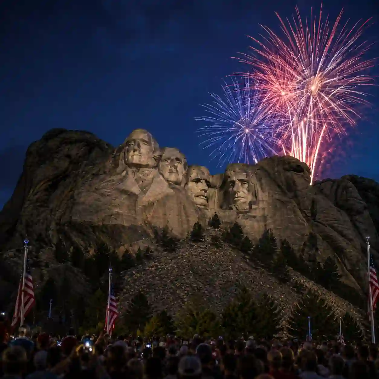 Mount Rushmore illuminated during the America 250 celebration with fireworks lighting the night sky as crowds gather for President Trump's July 3, 2026 event.