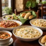 Bowls of pasta, salad, soup and breadsticks representing Olive Garden's Never-Ending Pasta Pass 2026 promotion.