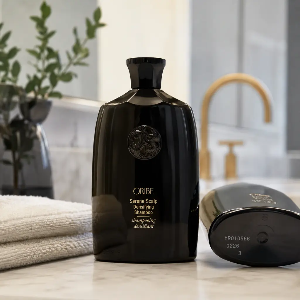 Oribe Serene Scalp Densifying Shampoo bottles displayed on a bathroom counter following the 2026 product recall over possible bacterial contamination.