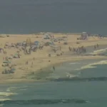 Aerial view of Point Lookout Beach on Long Island as lifeguards monitor the shoreline following a 9-foot shark sighting that prompted a temporary swimming closure.