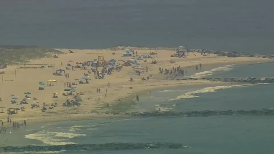 Aerial view of Point Lookout Beach on Long Island as lifeguards monitor the shoreline following a 9-foot shark sighting that prompted a temporary swimming closure.