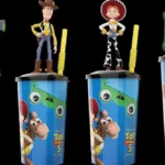 Toy Story-inspired collectible cups with decorative toppers displayed in a cinema, illustrating a product recall over a potential choking hazard.