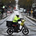 Food delivery rider on an e-bike in Australia amid new gig worker pay changes
