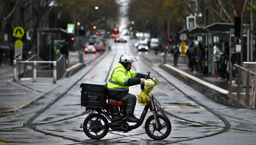 Food delivery rider on an e-bike in Australia amid new gig worker pay changes