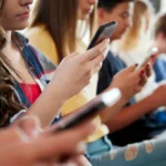 Australian teen using a smartphone amid under-16 social media restrictions