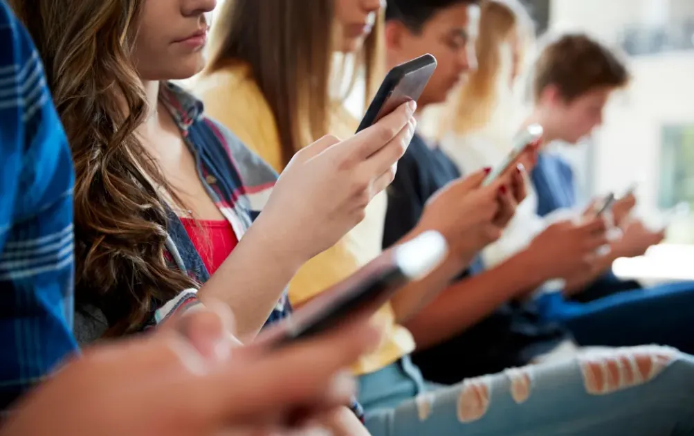 Australian teen using a smartphone amid under-16 social media restrictions