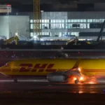 DHL cargo plane with flames near rear landing gear during landing at LAX