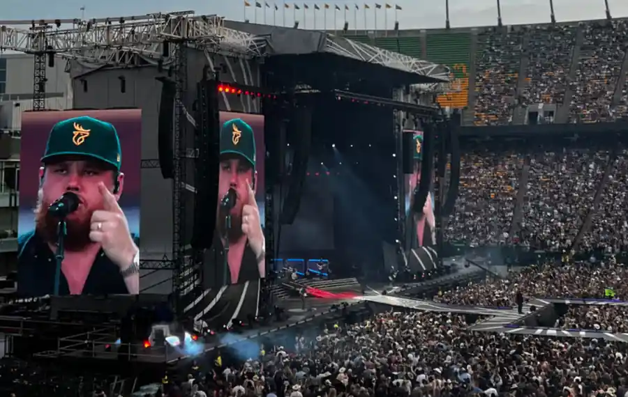 Luke Combs performing at a packed stadium concert