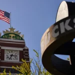 Starbucks headquarters in Seattle with an American flag as the company announces corporate layoffs in 2026